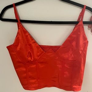 Red shiny v-neck tank top.